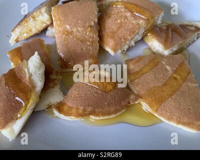 Scotch pancakes cut up with golden syrup on them Stock Photo