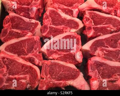 Selection of fresh lamb loin chops at the local butcher’s counter. Stock Photo