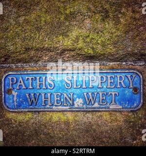 Paths slippery when wet sign Stock Photo