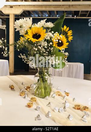 Bouquet of flowers in glass vase serving as table centerpiece for upcoming event Stock Photo