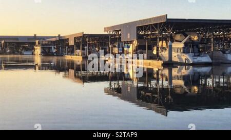 Discovery Bay, California. Northern California, boat marina with boats reflecting in the water while the sun is setting Stock Photo