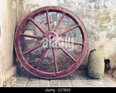 Old wooden wagon wheel in museum Stock Photo