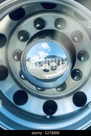 Different kind of selfie. Stopped in traffic, look over, and see myself in a hub cap Stock Photo