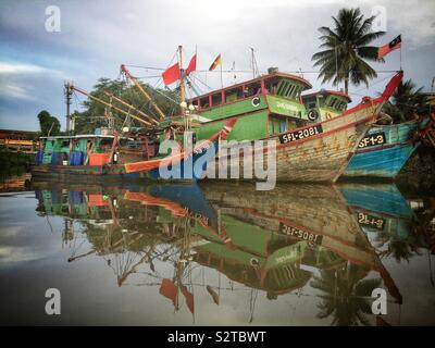 Fishing boats moored on the Sarawak River, Kuching, Sarawak, Malaysia Stock Photo