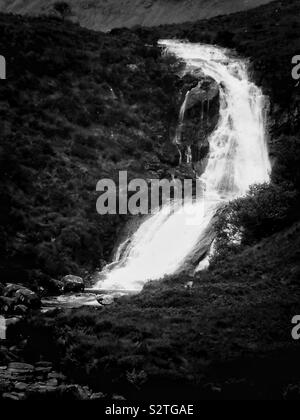 Black and white image of river gushing down mountain in wild remote landscape, Isle of Skye, Inner Hebrides, Scotland Stock Photo