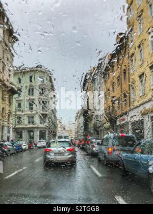 Rush hour traffic on a rainy day seen through a car window - Trieste, Italy Stock Photo