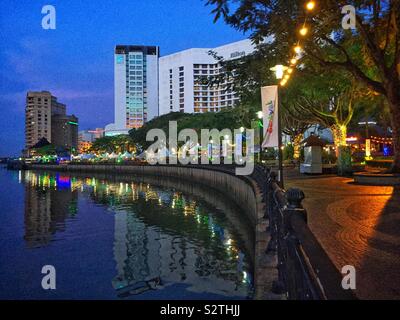 The Waterfront precinct on the south bank of the Sarawak River at twilight, Kuching, Sarawak, Malaysia Stock Photo