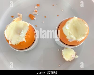 Two hard boiled eggs with tops off Stock Photo