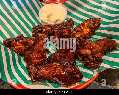 Bowl of bbq chicken wings and cream sauce Stock Photo