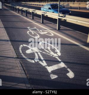 Cycle lane with bicycle markings beside road in Warsaw Poland Stock Photo