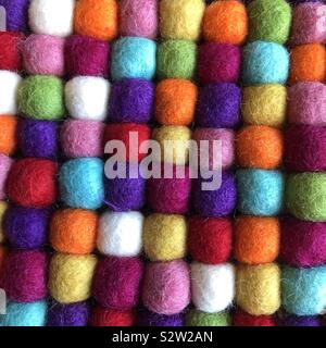 A closeup of many colorful wool balls aligned in rows and columns Stock Photo