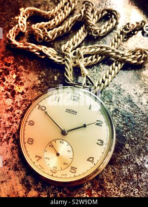 Still life of vintage Vulcain Grand Prix pocket watch and chain Stock Photo