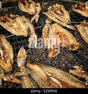 Fish drying on racks outside a dried seafood shop, Teluk Senangin Beach, near Lumut, Perak, Malaysia Stock Photo