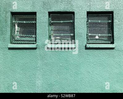 Three windows with security grille Stock Photo