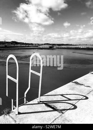 Metal ladder on harbour wall Stock Photo