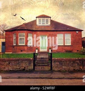 Little Red Brick House With Birds In The Sky Stock Photo