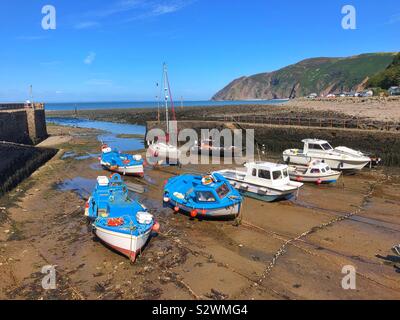 Boats in Lynmouth harbour, North Devon, low tide, August. Stock Photo