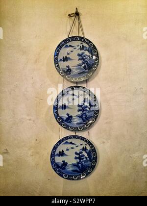 Antique Chinese plates on display in the lobby of Cheong Fatt Tze (aka The Blue Mansion), a late 19th century Chinese mansion now restored as a boutique hotel, George Town, Penang, Malaysia Stock Photo