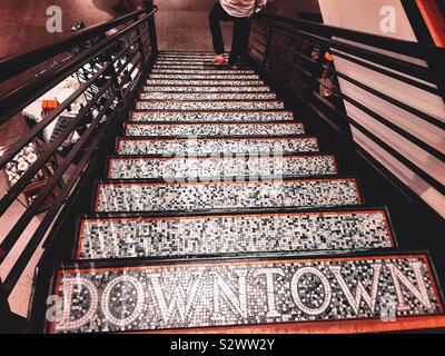Downtown labeled staircase leading to the lower level of the pottery barn in the flatiron district, Manhattan, NYC, USA Stock Photo