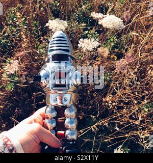 Vintage windup robot toy in grass Stock Photo