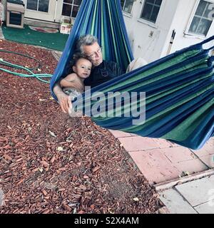 Grandpa and grandson on hammock Stock Photo
