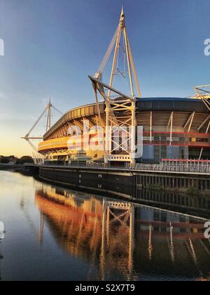 The Principality Stadium in Cardiff at sunset. It is located in the city centre on the banks of the River Taff Stock Photo