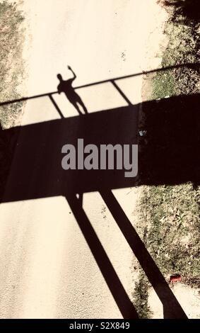 man's shadow on bridge Stock Photo - Alamy