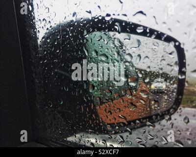 Water drops on car side mirror Stock Photo