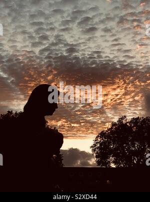 silhouette of person against dramatic sky Stock Photo - Alamy
