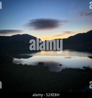 Dusk after Sunset, at Innominate Tarn, on Haystacks, in The English Lake District, Cumbria. Stock Photo