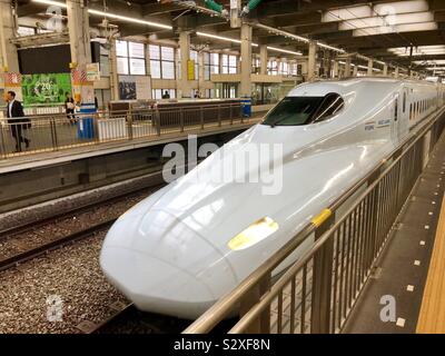 Bullet train arriving at the station in Japan. Stock Photo