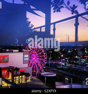 Evening view from the Hyatt Centric The Pike Long Beach’s rooftop pool deck of The Pike Outlets and Ferris wheel, Long Beach, California, United States Stock Photo