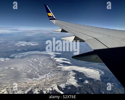 Keflavik, Iceland - September 2019: Flying over Iceland’s snow and glacier topped mountains en route to London Heathrow, UK. Stock Photo