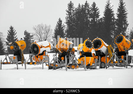 Snow gun machine waiting for frost with sun flare background, snowmaker  machine. Color effect Stock Photo - Alamy