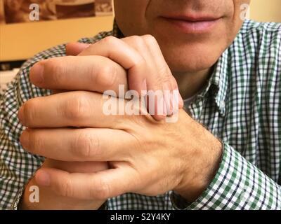 Man posing, crossing hands and smiling. Stock Photo