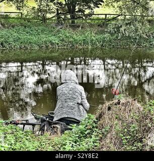 Man Fishing on the banks of the River Ouse Bedfordshire Stock Photo