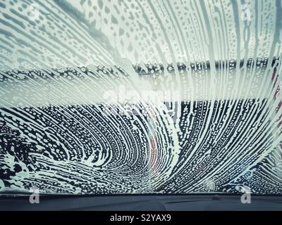Soaps suds on a windscreen in a car wash Stock Photo