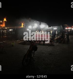 The night winds down at one of the many pop-up restaurants that cover Marrakech’s square each evening. Stock Photo