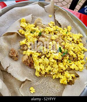 Enkulal be tibs firfir is a traditional Ethiopian breakfast. Stock Photo