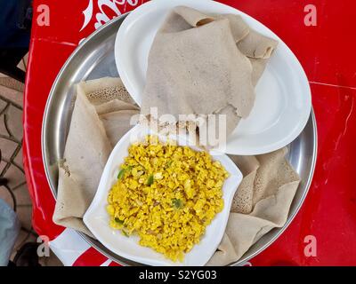 Enkulal be tibs firfir is a traditional Ethiopian breakfast. Stock Photo