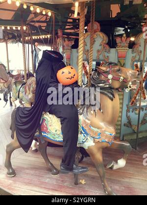 Headless horseman statue on a carousel horse during the Halloween season on the merry-go-round in Bryant Park, NYC, USA Stock Photo