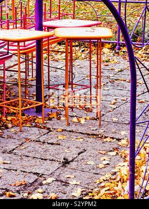 Colourful cafe outdoor terrace stools and autumn leaves, Sweden Stock Photo