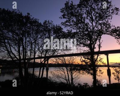 Sunset over the Cleddau River by the Cleddau Bridge at Burton, near Milford Haven, Pembrokeshire, Wales, UK. Stock Photo