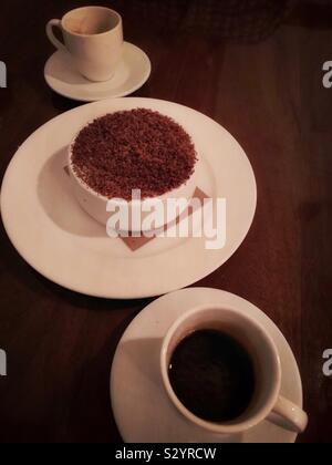 Tiramisu is served along with two espresso coffees. Stock Photo
