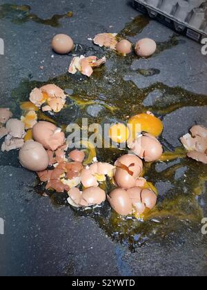 Close up of a dozen broken eggs on urban sidewalk, USA Stock Photo