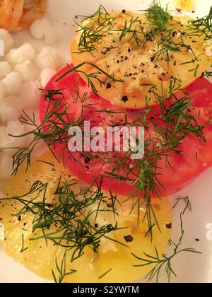 Close up of heirloom tomatoes garnished with fresh dill, United States Stock Photo
