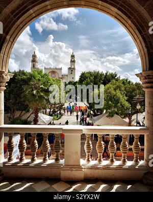 From the second floor of the Palacio Municipal, Mérida’s historic center including the Plaza Grande, the colorful Mérida city name in giant letters, and the Catedral de San Ildefonso are visible. Stock Photo