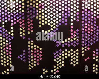 Patterns and design of metal grate with a lighted colorful background Stock Photo