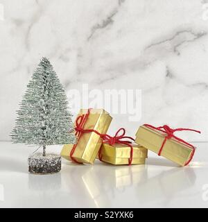 Christmas tree with gold gift boxes and red ribbons Stock Photo