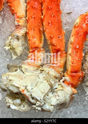 Fresh Alaskan king crab legs displayed on ice Stock Photo